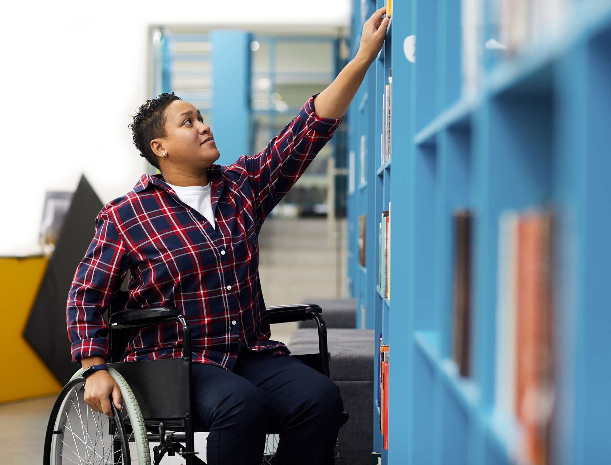 independent disabled student in library