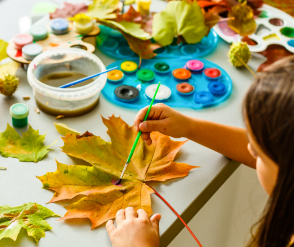Early Explorers Prep Art Activity Student painting on a leaf as a part of ABA Services